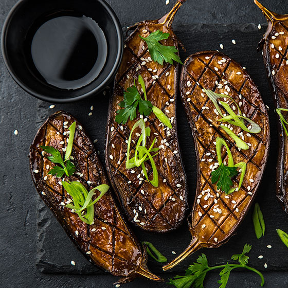 Glazed grilled eggplants with Umami Booster served with sesame seeds and green onion